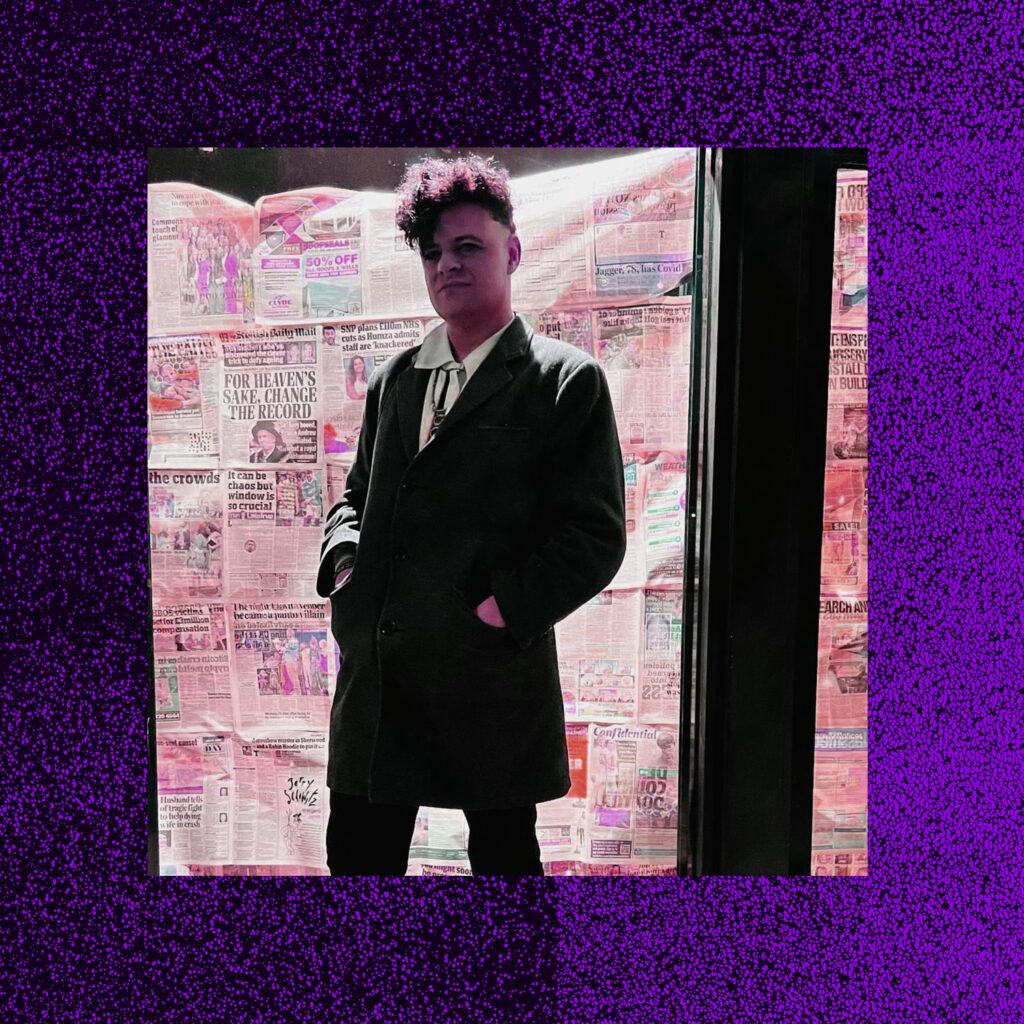 Soft Riot against a wall of newspapers